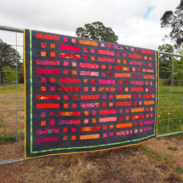 Bushfire quilt is well suited to strong fabric colour choices